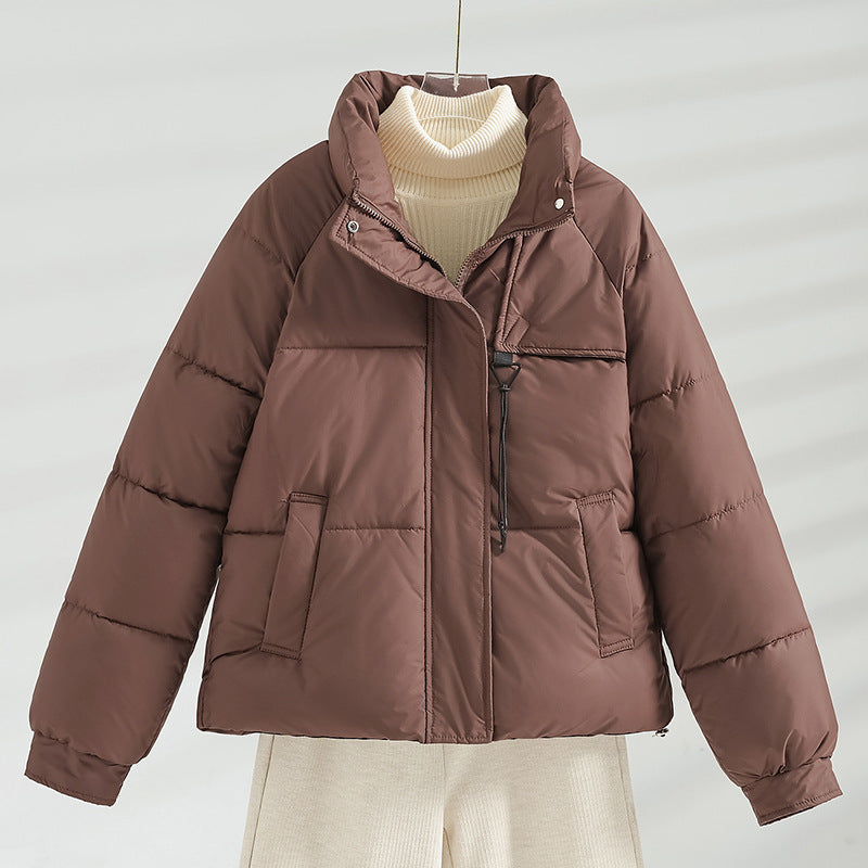 Women's short padded jacket with a boxy fit, stand-up collar, and drawstring.