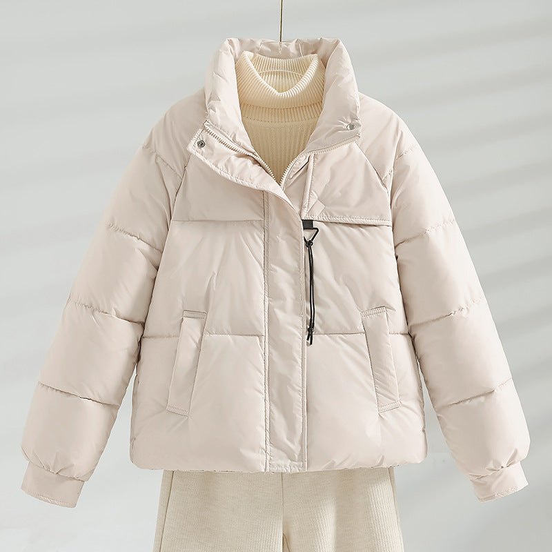 Women's short padded jacket with a boxy fit, stand-up collar, and drawstring.