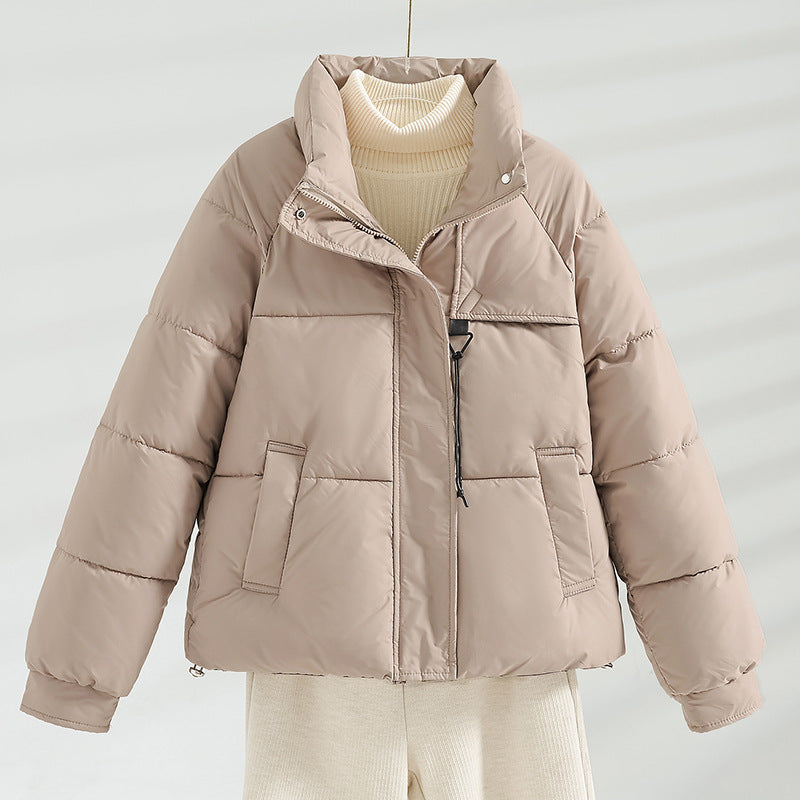 Women's short padded jacket with a boxy fit, stand-up collar, and drawstring.