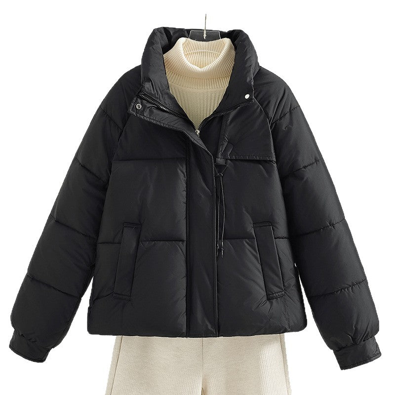 Women's short padded jacket with a boxy fit, stand-up collar, and drawstring.