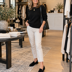 Woman wearing Noira black suede loafers inside Jennifer Dallas Boutique